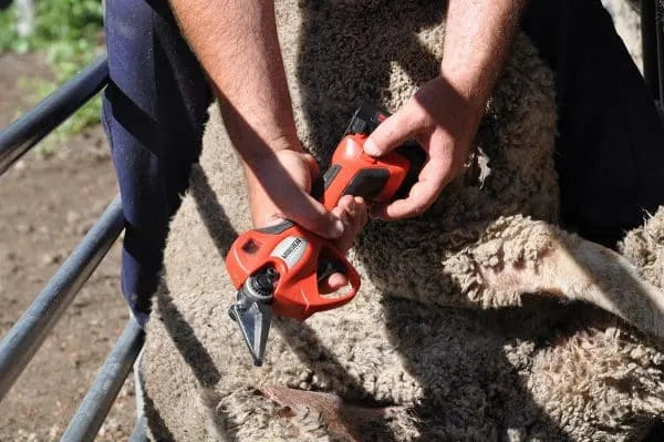 Side view of Mobishear 37mm hoof trimming secateur with foot paring blades attached and closed showing hand pulling trigger to change aperture opening.